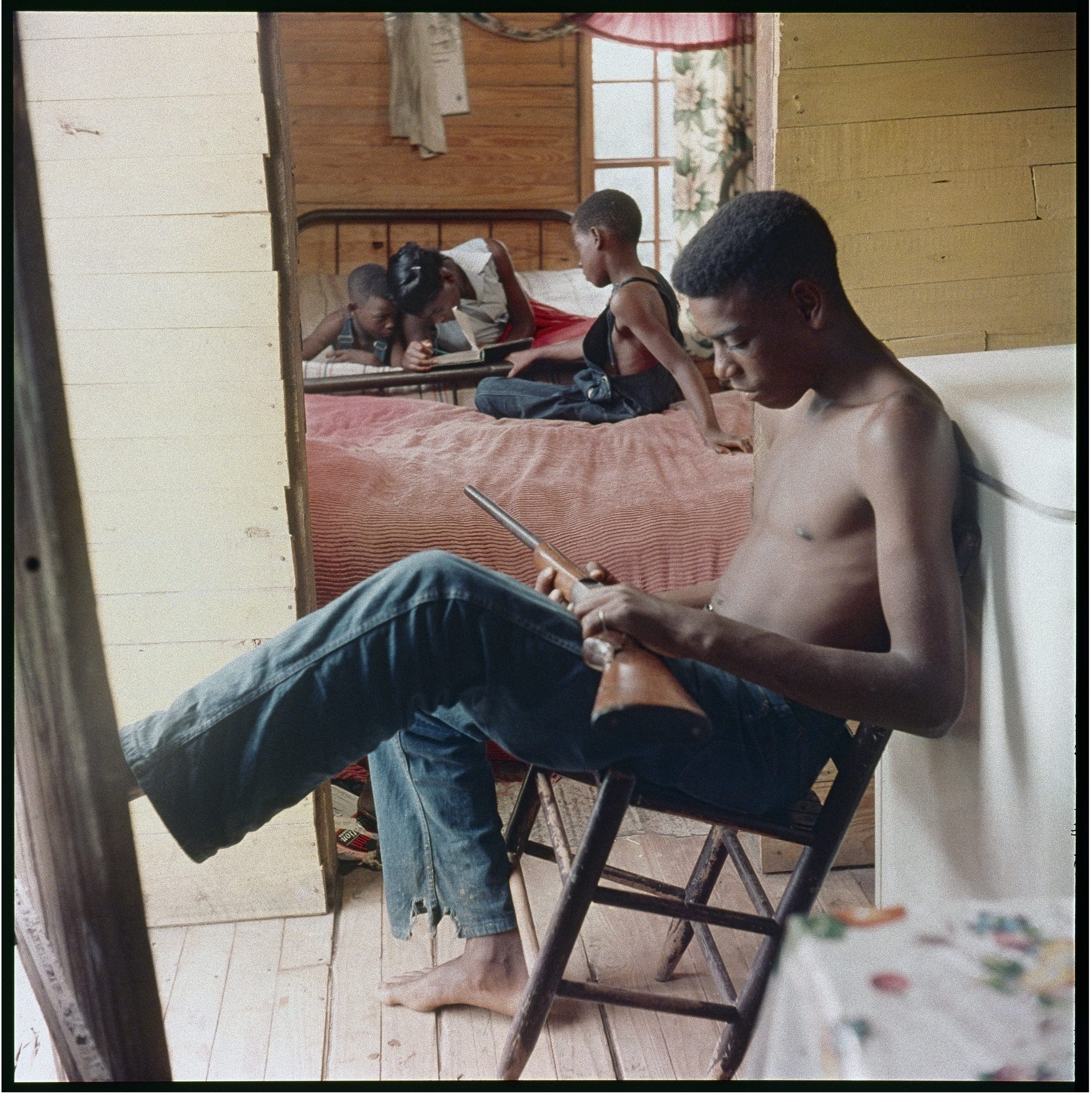 Gordon Parks (American, 1912–2006), Willie Causey, Jr., with Gun During Violence in Alabama, Shady Grove, Alabama, 1956, courtesy of and copyright The Gordon Parks Foundation.