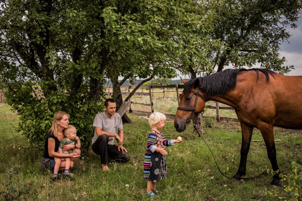 Photographie de Anastasia Taylor-Lind montrant une famille avec un cheval dans le Donbass, 2018.